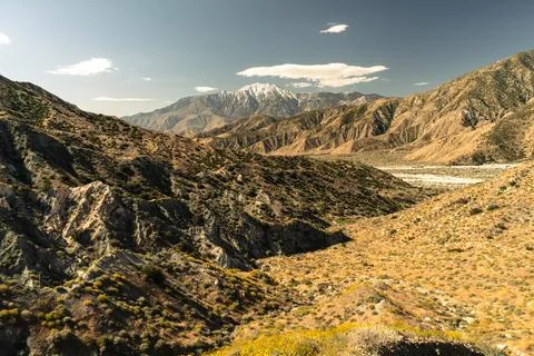 A mountain range with a cloudy sky in the background Stock Photos