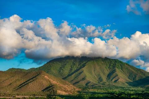 A mountain range with a cloudy sky in the background Fotos Stock