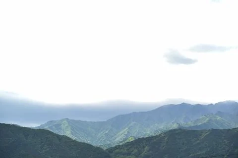 A mountain range with a cloudy sky in the background Stock Photos