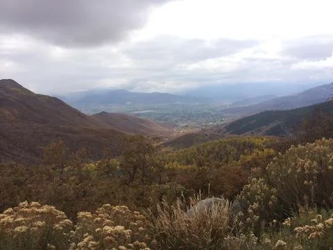 A mountain range with a cloudy sky in the background Stock Photos