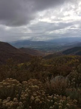A mountain range with a cloudy sky in the background Stock Photos