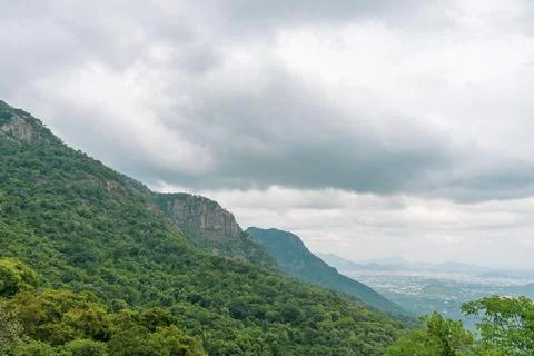 A mountain range with a cloudy sky in the background Stockfoto's