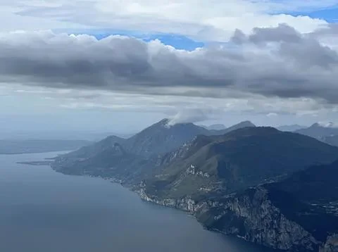Mountain range with cloudy sky over a large lake Stock Photos