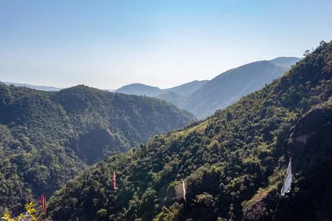 Mountain range covered with green forests and misty blue sky at morning from  스톡 사진