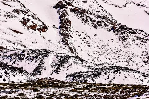 A mountain range covered in snow and rocks Stock Photos