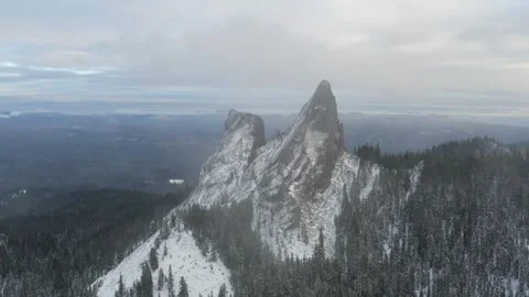 A mountain range covered in snow with a large peak in the middle Stock Footage 273742499