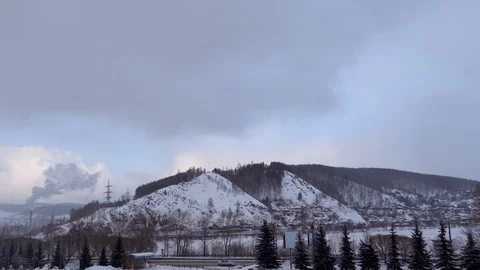 Mountain range covered with snow with a small lake and road Video stock 104389742