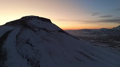 A mountain range covered in snow at sunset time Stock Footage 328249427