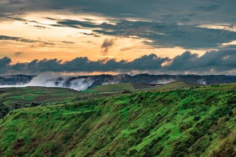 Mountain range with dramatic sunset blue sky and low clouds at evening 写真素材