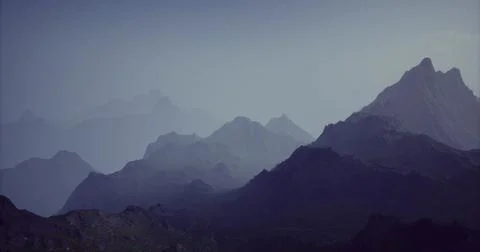 Mountain range fading into twilight with layered peaks and soft hues Stock Illustration