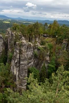 A mountain range with a forest on top Stock Photos