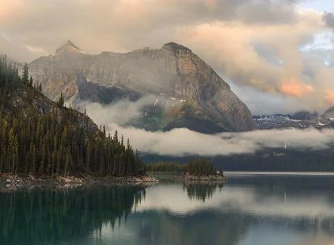 A mountain range with a lake in the foreground Stock Photos
