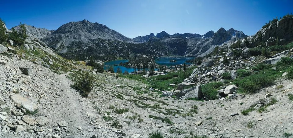A mountain range with a lake in the foreground Stock Photos