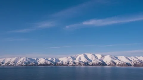 Mountain range on the lake shore covered with snow, Sevan, timelapse, 4k Stock Footage 272623760