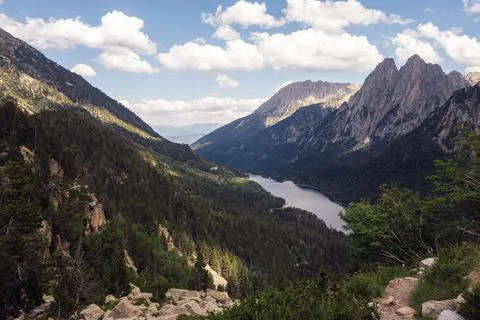 Mountain range with a lake in the valley Stock Photos