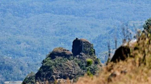 A mountain range with a large rock in the middle Stock Photos