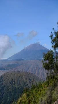 A mountain range with a large volcano in the middle 写真素材