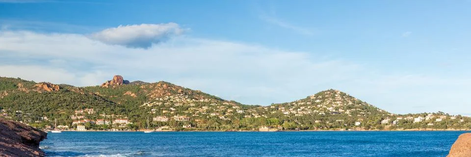 Mountain range with lone cloud in the blue sky on the on the French Riviera c Stock Photos