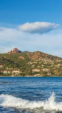 Mountain range with lone cloud in the blue sky on the on the French Riviera c Stock Photos