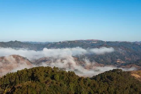 Mountain range with low cloud and bright blue sky at morning Photos
