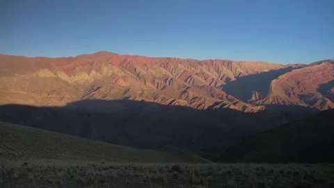 Mountain range with multiple shades of red, around Purmamarca, Argentina Stock Footage 237286299