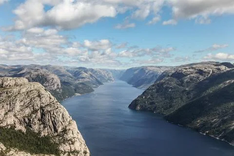A mountain range in Norway overlooking the Luse Fjord from the Preikestolen.. Stock Photos