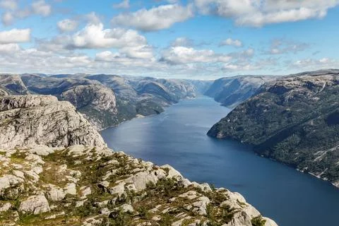 A mountain range in Norway overlooking the Luse Fjord from the Preikestolen.. Stock Photos