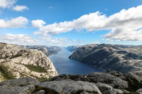 A mountain range in Norway overlooking the Luse Fjord from the Preikestolen.. Stock Photos