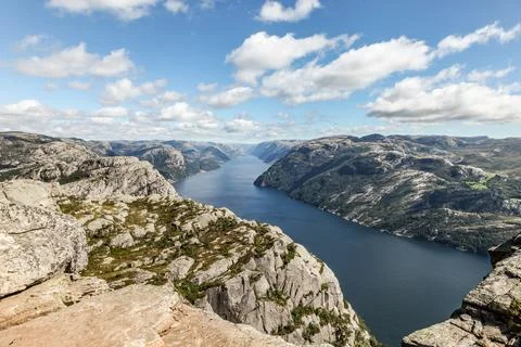 A mountain range in Norway overlooking the Luse Fjord from the Preikestolen.. Stock Photos