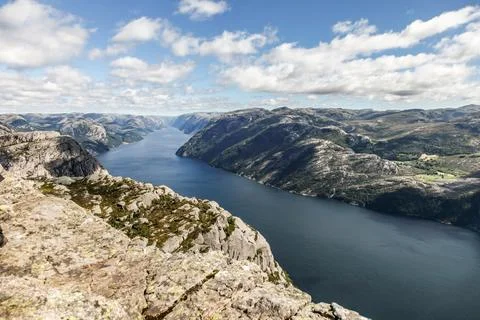 A mountain range in Norway overlooking the Luse Fjord from the Preikestolen.. Stock Photos