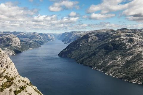 A mountain range in Norway overlooking the Luse Fjord from the Preikestolen.. Stock Photos