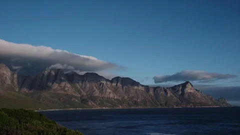 Mountain Range by the Ocean Dramatic Clouds at Sunset, Slow Motion Stock Footage 337969755