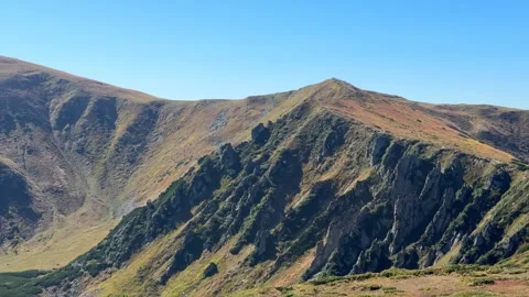 Mountain range panning over rugged ridges and slopes Stock Footage 318488678