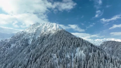 Mountain range peak covered in snow blue sky with clouds aerial view winter Stock Footage 171389600