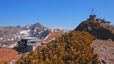 Mountain range peaks with snow, ski lift station and people hikers Stock Footage 121551044