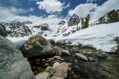 A mountain range with a river flowing through it Stock Photos