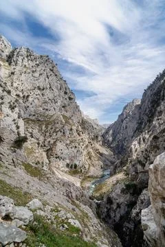 A mountain range with a river running through it Stock Photos