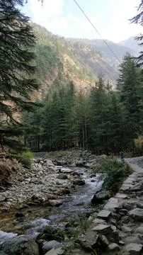 A mountain range with a river running through it. Kasol, Parvati Valley, Hi.. 写真素材