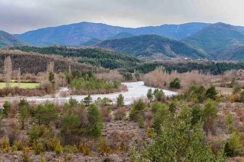 A mountain range with a river running through it Stock Photos