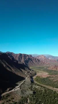A mountain range with a river running through it Stock Photos