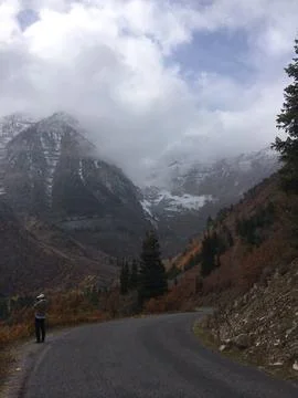 A mountain range with a road in the middle Stock Photos