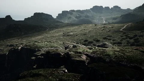 A mountain range with rocks and grass in the foreground. mountain path Stock Illustration