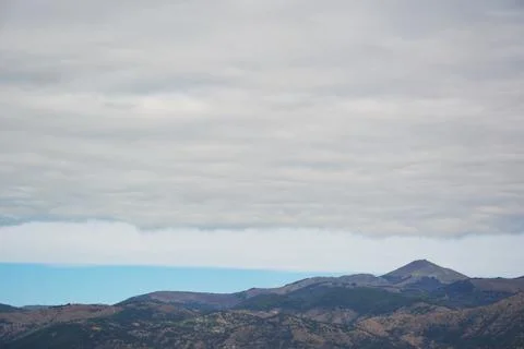 Mountain range scenery with ususual clouds Stock Photos
