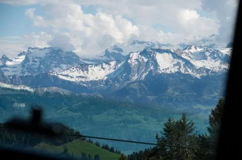 Mountain range seen from mount rigi train window descending down the mountain Stock Photos