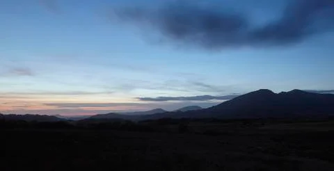 Mountain range silhouette at sunset Stock Photos