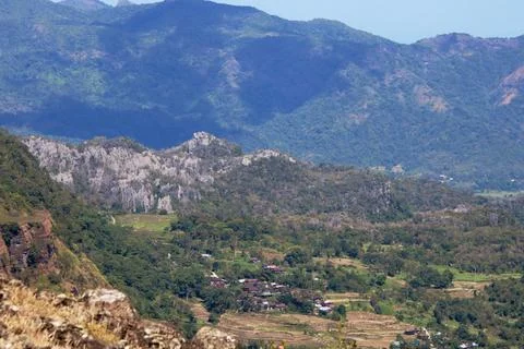 A mountain range with a small town in the valley below Stock Photos