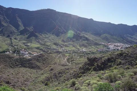 A mountain range with a small town in the valley Stock Photos