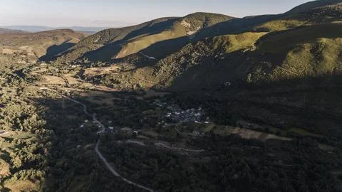 A mountain range with a small town in the valley Stock Photos