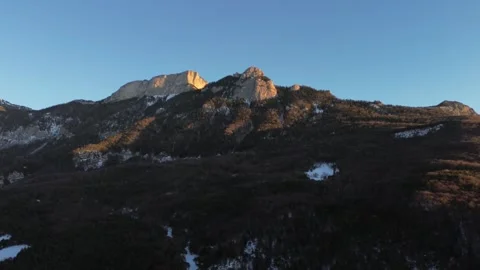 A mountain range with snow and trees in the background Video stock 328615495