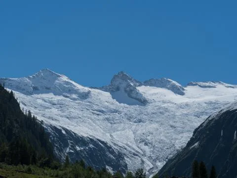Mountain range snow capped and clear blue sky Stock Photos